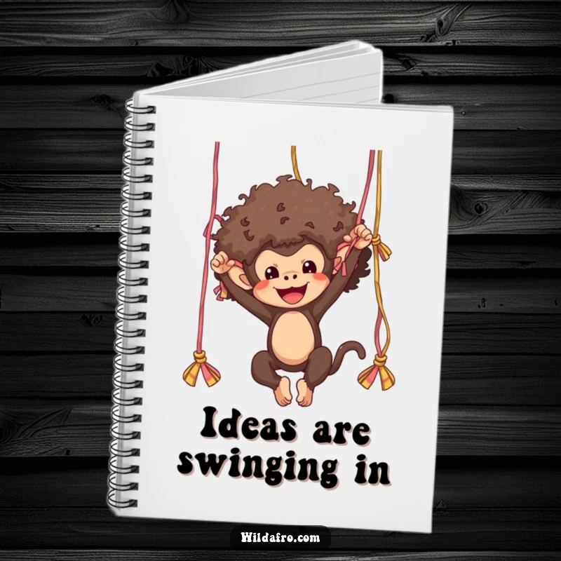 Funny monkey with a cool afro swinging from yarn strands, gracing the cover of a humorous and practical notebook.